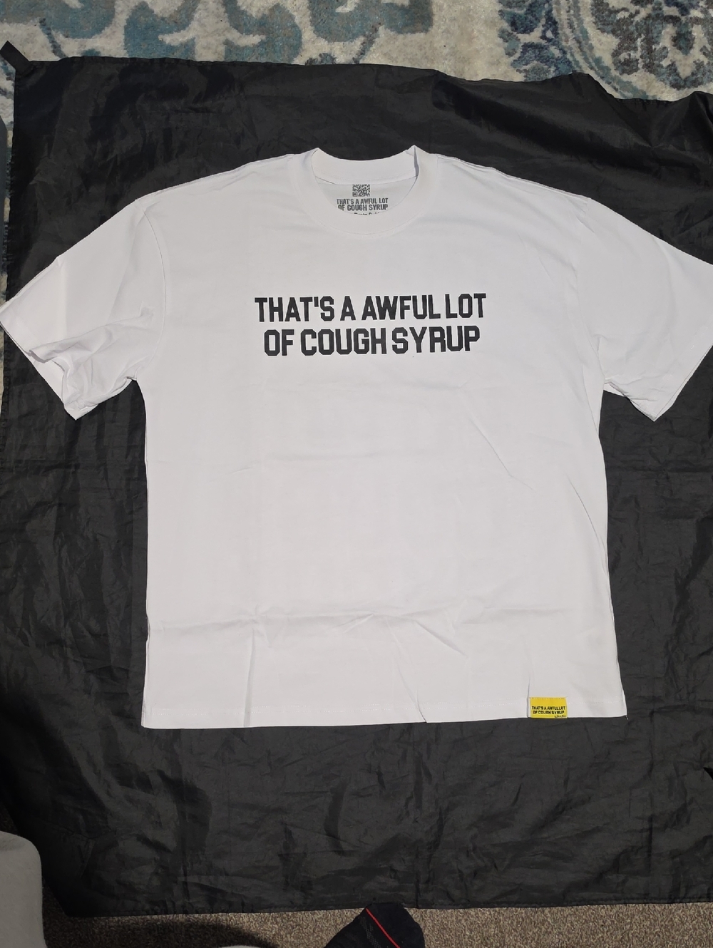 White Graphic Tee with 'That's A Awful Lot Of Cough Syrup' Text